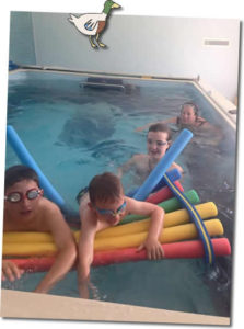 children having fun in the endless indoor swimming pool at Higher Lank Farm