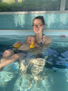 mum and baby enjoying a swim in the warm swimming pool at Higher Lank Farm