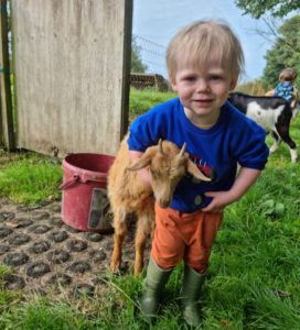 autistic child playing with goat